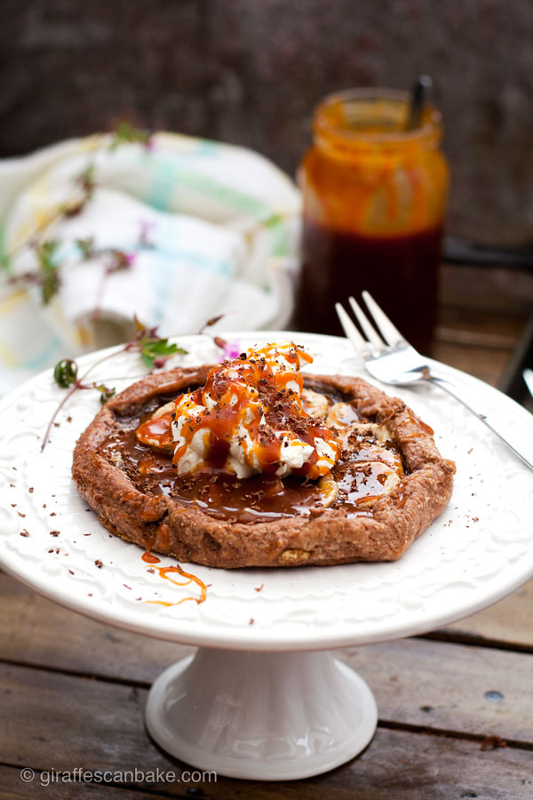 Banana and Salted Caramel Banoffee Galettes - A sinfully indulgent rustic free-form tart. Chocolately pastry is home to sweet bananas and salted caramel, topped with fresh whipped cream and grated chocolate. So simple to make with 5 minute caramel sauce, you won't regret making this!