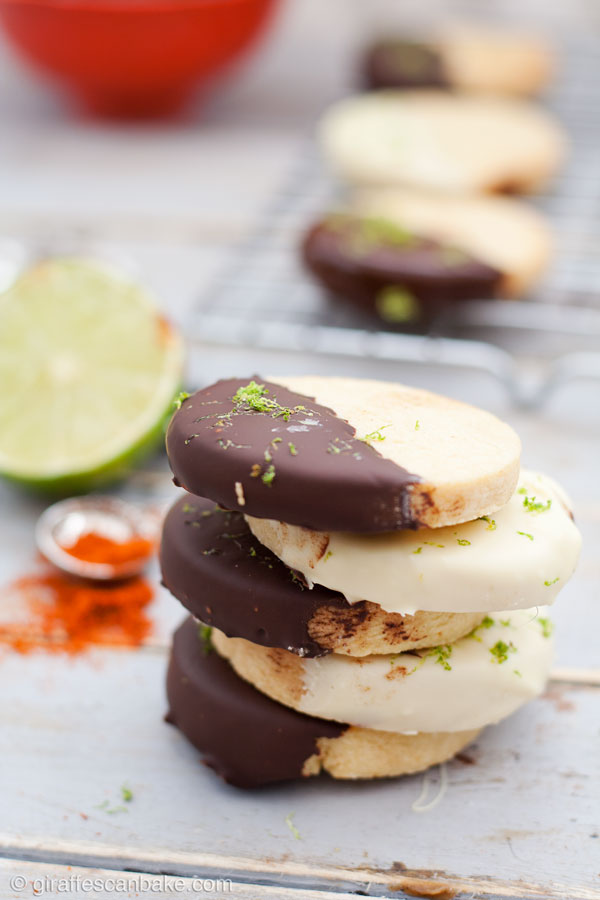 Sweet and Spicy Shortbread Cookies - crumbly, melt in your mouth shortbread cookies are flavoured with spicy cayenne pepper and zesty lime, then dipped in chocolate for extra indulgence. These easy to make chocolate dipped chili lime shortbread cookies are sure to satisfy everyone! 