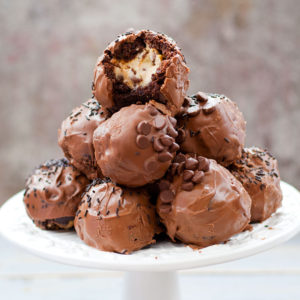 Gluten Free Cookie Dough Brownie Bombs with Salted Caramel - These Cookie Dough Brownie Bombs with Salted Caramel are indulgence on top of decadence! Eggless chocolate chip cookie dough is dipped in salted caramel, then enclosed in chocolate salted caramel brownies, and dipped in chocolate. They're gluten free, so easy to make and absolutely to die for!