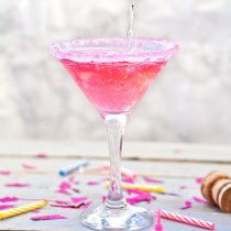 The Rory Cocktail is a very pink drink, made from pineapple vodka, grenadine and champagne or prosecco, served in a martini glass with a pink sugar rim! A really fun, easy and yummy cocktail to celebrate the return of Gilmore Girls with cocktails and girl power!!