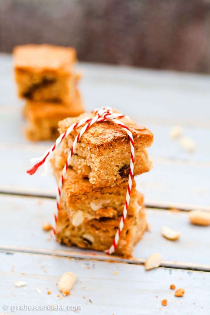 Gluten Free Triple Peanut Blondies - Chewy, moist and packed full of delicious peanut goodness. A peanut butter lover's dream come true! - A tower of three blondies tied in a ribbon
