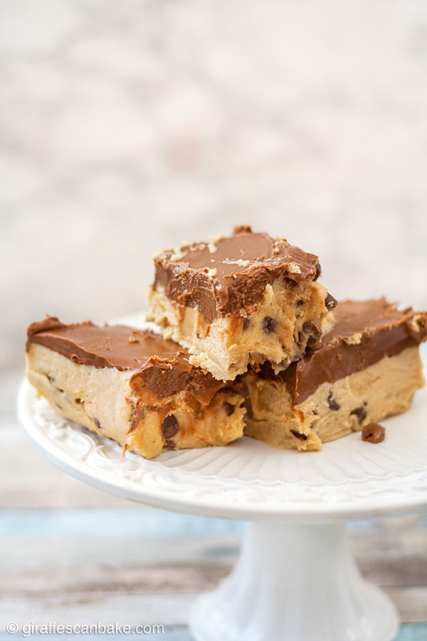 These Gluten Free Peanut Butter Cookie Dough Bars are decadence at its finest! Soft, delicious gluten free cookie dough is combined with peanut butter, made into a bar and topped with chocolate and peanut butter combined. They're no bake, so easy to make, and absolutely yummy!