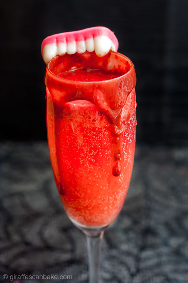 The Bloody Bellini, delicious blood is combined with bubbly prosecco to make the perfect Halloween Cocktail for Vampires, and those suffering with anaemia. If you're not a vampire, you can make this gruesome looking cocktail with Raspberry Puree and Raspberry Chocolate Syrup! Perfect to serve this halloween, and totally delicious too! #halloween #cocktail #bellini 
