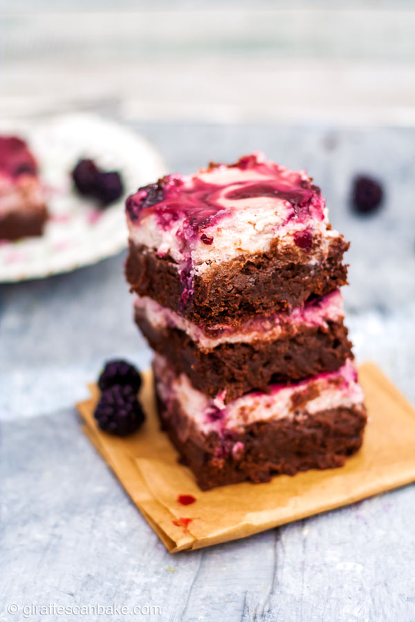 These Gluten Free Blackberry Cheesecake Brownies are chocolatey, creamy, and fruity! Fudgy brownies are topped with a thick and creamy blackberry cheesecake. So quick and easy to make, and a real crowd pleaser. Gluten free decadence! #glutenfree #brownies #cheesecake #blackberry