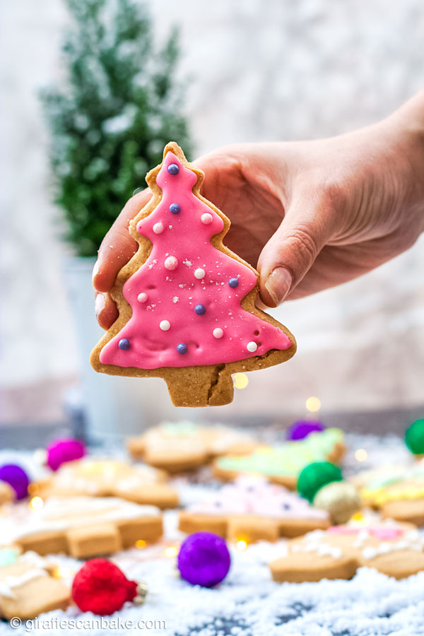 These buttery, melt in your mouth Gluten Free Shortbread Cookies with Cinnamon & Clementine are the perfect Christmas cookies - a christmas tree shaped cookie decorated with pink royal icing