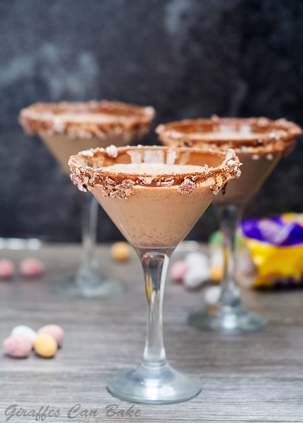 Mini Egg Chocolate Martini - three martini glasses with chocolate coloured liquid, mini eggs scattered in background. 